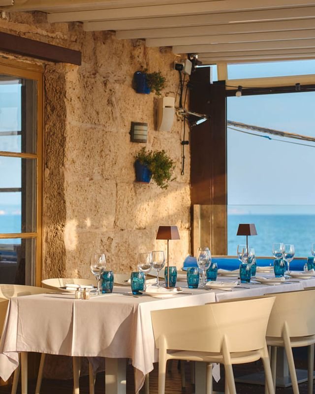 Mesa junto a la ventana de piedra con vistas al mar